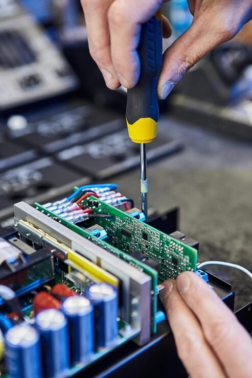 repairing-hardware-equipment-repair-shop-worker-with-tools-microchip-circuit-board-testing-modern-digital-device-desk-electronic-devices-concept_194143-2751